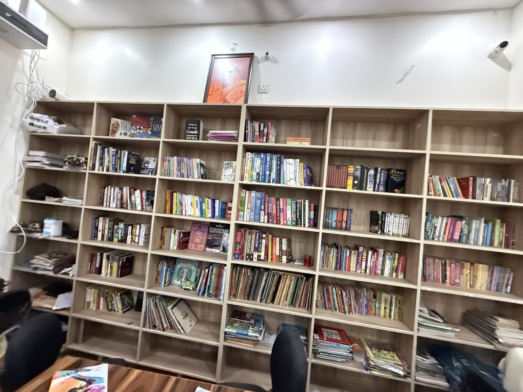 ★ Book wall (hero candidate B — full wall)